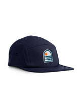 Sutsu Sun & Waves 5 Panel Cap - navy baseball cap on white background - sustainable headwear with sun and sea badge.