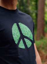 Close up of a Sutsu Peace Out T-Shirt - a black organic cotton, graphic tee with peace symbol and green leaves design.