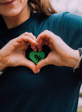 Close up of the Tree Love EMB Sweatshirt - an organic cotton sweatshirt in teal with an embroidered tree and heart graphic from Sutsu.