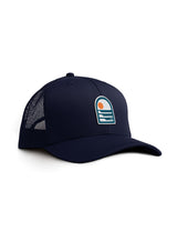 Navy blue Sutsu Sun & Waves Trucker Cap - a sustainable cap featuring an abstract sun and waves graphic badge.