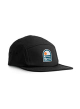Sutsu Sun & Waves 5 Panel Cap - black baseball cap on white background - designer headwear with sun and sea logo.