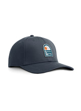 Sutsu Sun & Waves Ranger Cap - a petrol blue branded cap featuring sun and sea graphic.