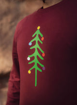Close up of the Christmas tree and baubles design on the burgundy Sutsu Xmas Tree Slim Fit Sweatshirt.